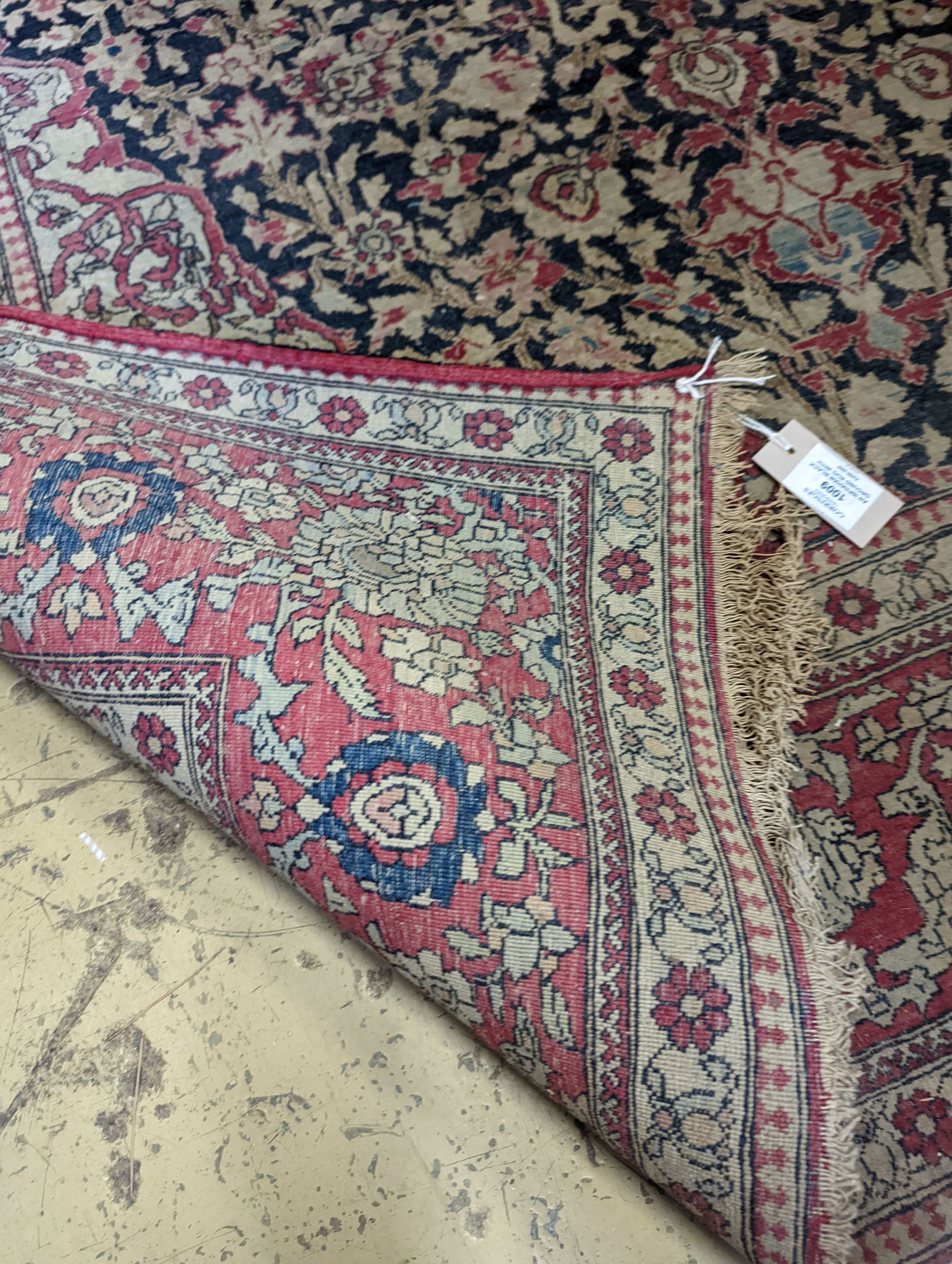 An Isphahan black ground rug with central foliate medallion, mulit-bordered, 202 x140cm